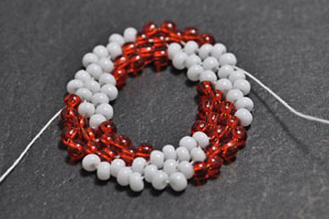 Step 1d: Add two beads in between the beads strung in Round 3