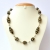 Handmade Necklace with Black Beads having Silver & Golden Flowers