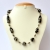 Handmade Necklace with Black Beads having Metal Accessories