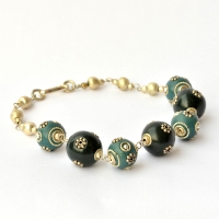 Handmade Bracelet having Black & Blue Beads Studded with Metal Flowers